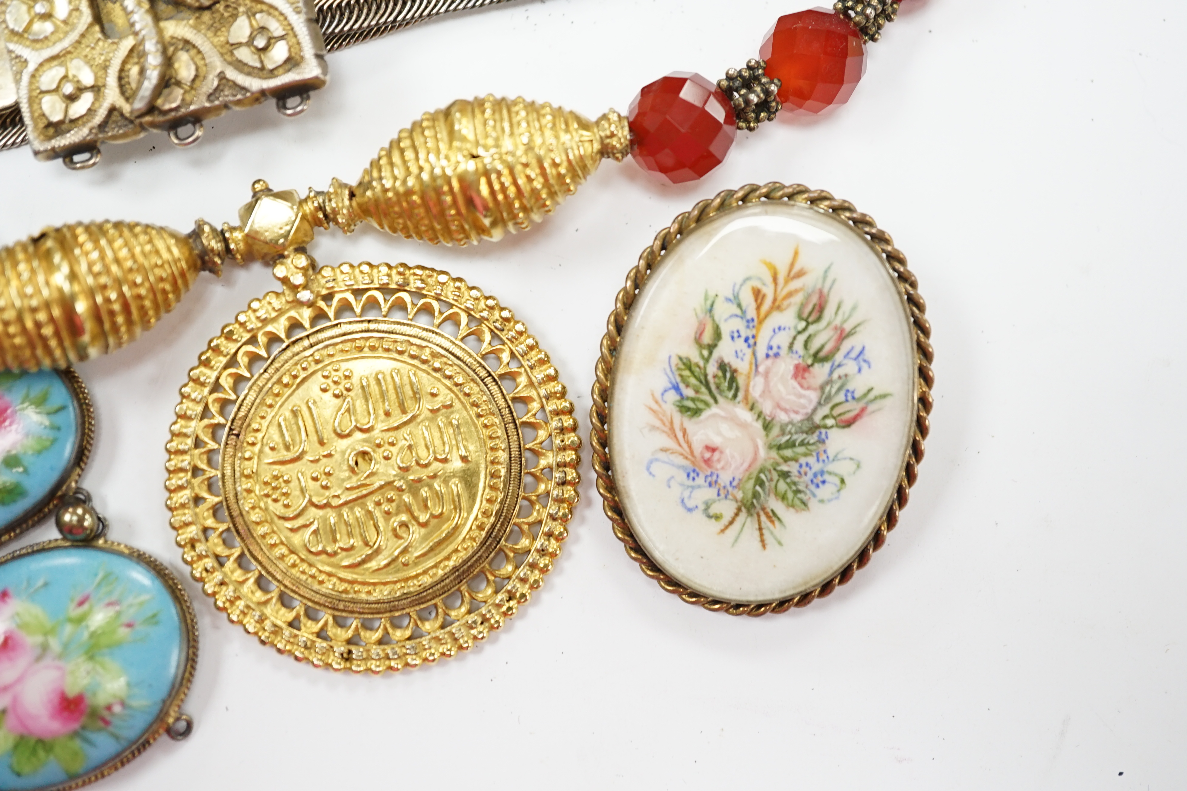 A group of assorted jewellery, including a Persian gilt white metal belt and a French gilt white metal and graduated porcelain plaque set bracelet. Fair condition.